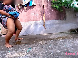 An Indian lady is taking a dump on the street, uninhibited.